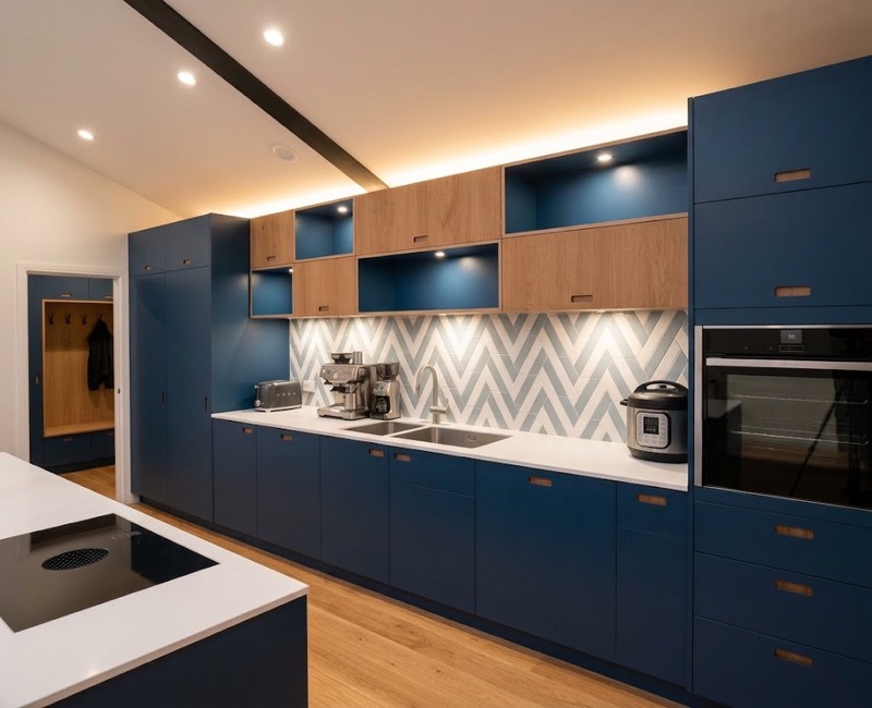 Navy blue bespoke kitchen and pantry units with oak shelving.