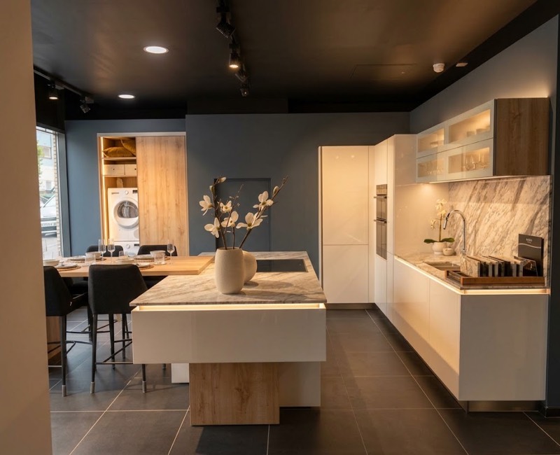 Gloss white kitchen with an oak-clad island, marble splashback and integrated appliances.